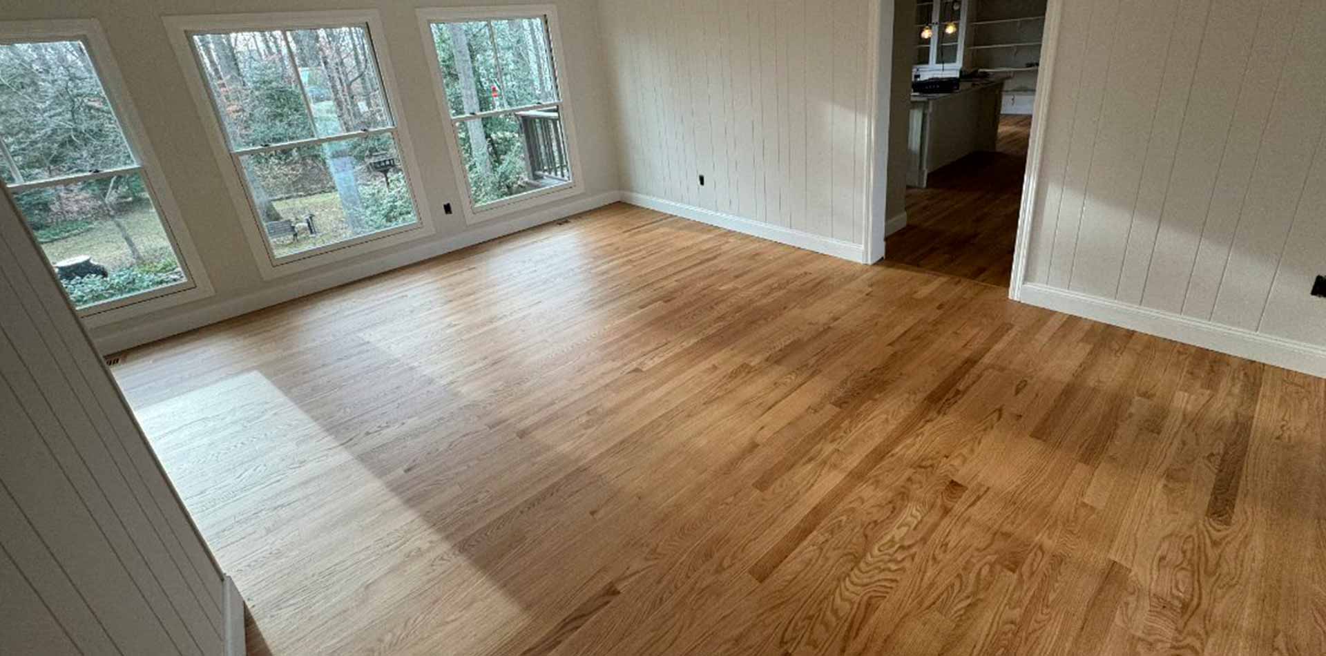 Freshly refinished red oak floor in a sunlit DMV home