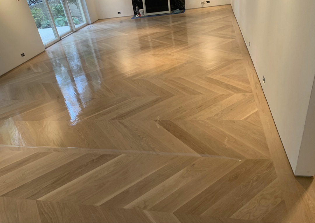 Custom chevron herringbone hardwood floor installation by Pineda Hardwood Floors